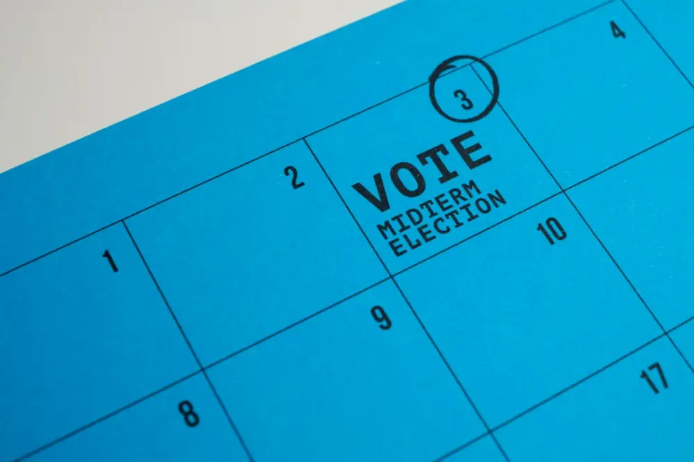 A blue calendar page with the third day circled and marked vote midterm election, illustrating election cycle forecasting